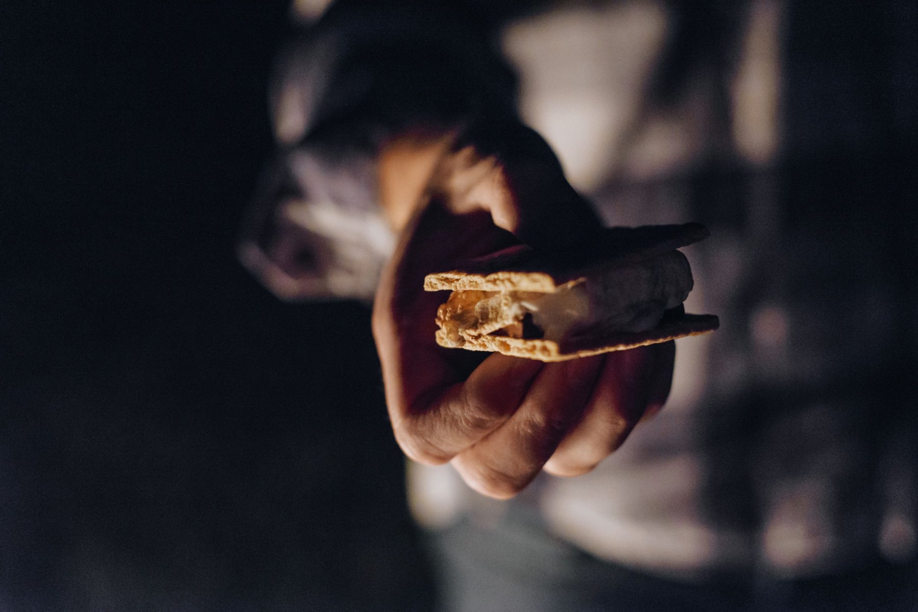 S'more held by the campfire